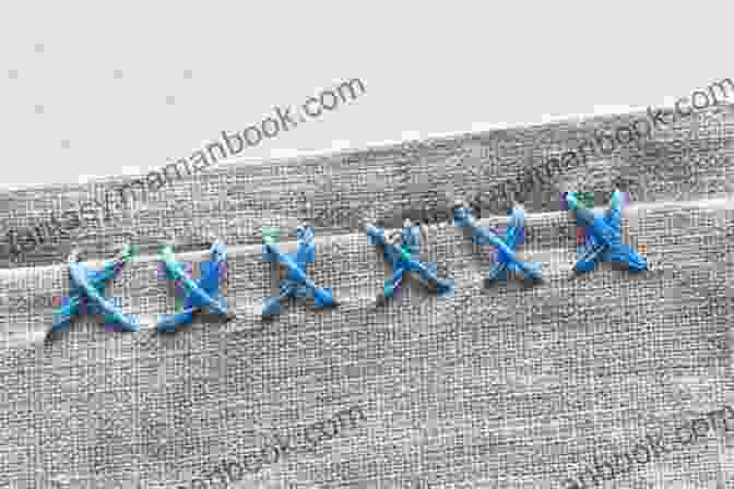 A Close Up Photo Of A Split Stitch In White Thread On Blue Fabric. HAND EMROIDERY STITCHES FOR BEGINNERS: The Complete Step By Step Guide To Learn The Basic Stitches And Acquire The Skill And Techniques To Create Awesome Embroidery Stitches
